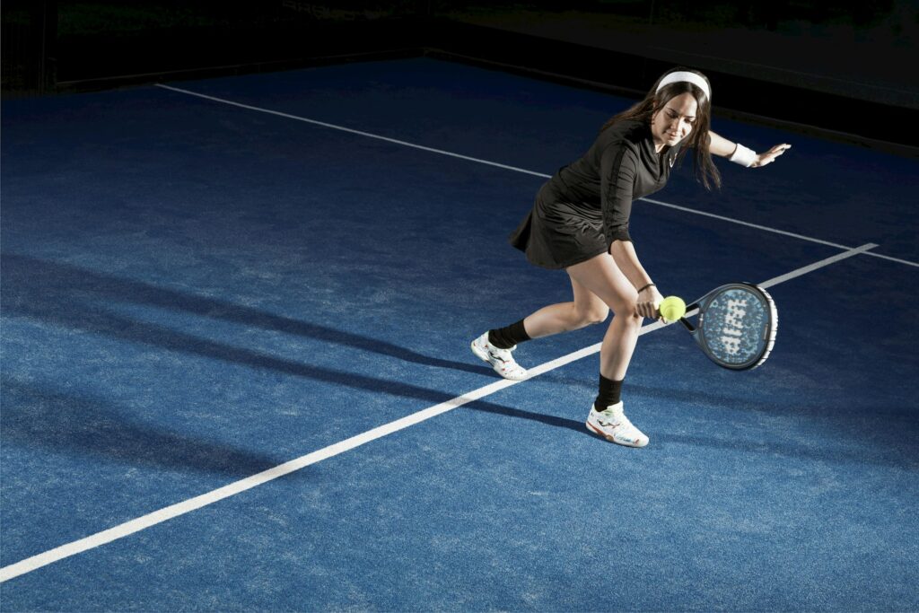 Female athlete hitting a competitive forehand shot, showcasing the best alternative to adult sports leagues in Utah.